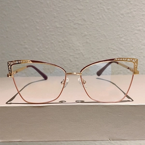 Detail of rose gold cat-eye glasses frame with geometric hollow-out design and nose pads