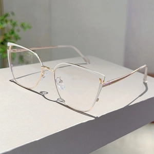 Detail of cat-eye frames with white trim, rose gold metal arms and silicone nose pads