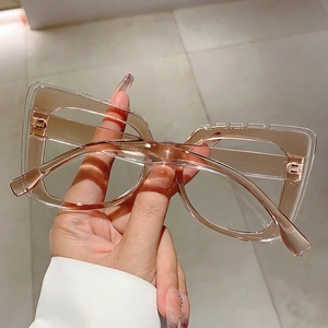Close-up of translucent champagne oversized square glasses with model W68158 marking