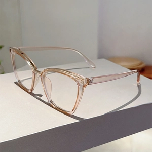 Detailed close-up of champagne gold hinge on translucent cat-eye glasses frame