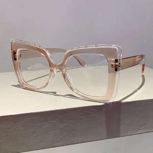 Detail of oversized cat-eye glasses with transparent double-layer frame and step texture