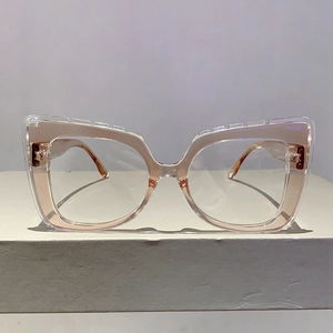 Detailed close-up of stylish cat-eye frames with dual-layer transparent and pink finish