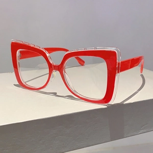 Detail of red and transparent dual-layer cat-eye frame glasses on a geometric stand