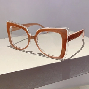 Detail of dual-layer cat-eye frames featuring transparent and caramel brown finishes