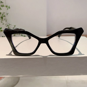 Detailed view of glossy black butterfly cat-eye frame glasses on a white display