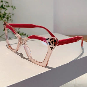 Detail of trendy butterfly cat-eye glasses with pink resin frames and red leopard accents
