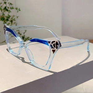 Detail of light blue cat-eye glasses with tortoiseshell accents on a white display