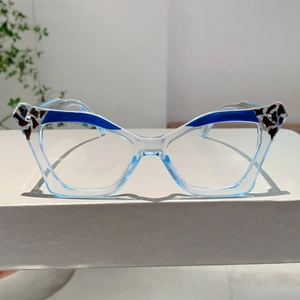 Close-up of cat-eye glasses frame in transparent blue with leopard print accents
