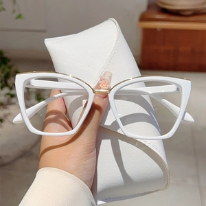 White cat-eye blue light blocking glasses with gold metal trim and matching leather case