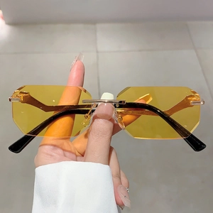 Rimless geometric sunglasses with yellow tinted lenses and gold metal leopard temple design