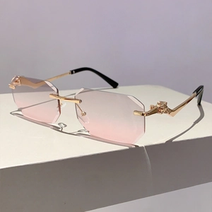 Detail of rimless polygon pink gradient lenses and golden leopard head decor on temples