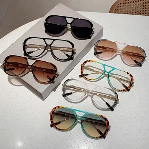 Retro pilot sunglasses and leopard frames with double bridge design on minimalist display