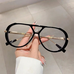 Retro oversized eyewear frame with black acetate rim and textured gold metal temples