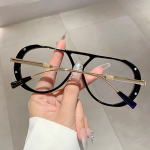 Detail of pilot glasses frame with silver rhinestones and gold metal temples