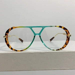 Detailed close-up of tortoise shell frame glasses with a unique blue bridge and gold temples