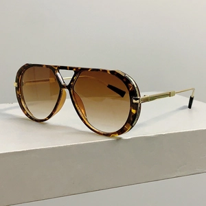 Close-up of tortoise shell frames and engraved gold metal temples of aviator sunglasses
