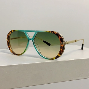 Detail of tortoise and teal pilot sunglasses frame with brown gradient resin lenses