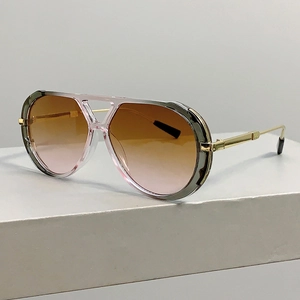 Detail of pilot sunglasses with leopard gradient lenses and gold metal temples