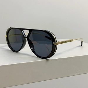 Detail of vintage pilot sunglasses with leopard-style thick frames and gold temples