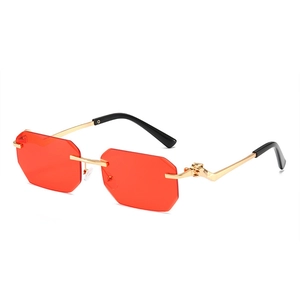 Rimless octagonal sunglasses with red lenses and gold leopard hinge detailing