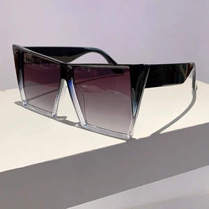 Détail de lunettes de soleil carrées oversize avec monture bicolore et verres dégradés