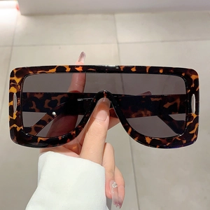 Close-up of oversized tortoiseshell sunglasses with dark lenses and silver metal trim