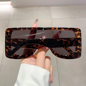 Close-up of tortoise shell square oversized sunglasses with subtle crystal detail