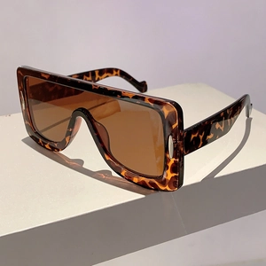 Macro detail of oversized square leopard print sunglasses with premium dark brown lenses