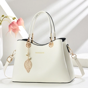 Elegant off-white textured leather handbag with gold leaf charm and pearl accent