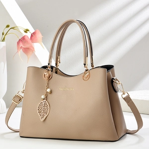 Elegant apricot lychee texture tote bag with gold hardware and leaf pearl pendant