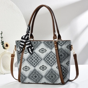 Fashionable grey geometric pattern tote bag with brown leather straps and scarf detail