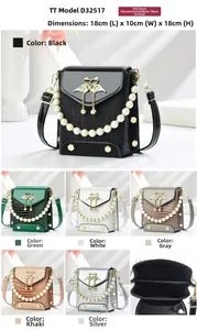 Detail view of crocodile-patterned phone bag with swan buckle and pearl shoulder strap