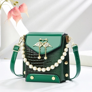 Emerald green crocodile pattern mini crossbody bag with pearl handle and swan buckle