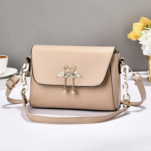 Beige faux leather crossbody bag with swan pearl clasp and acrylic chain strap