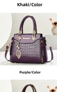 Detail of purple crocodile pattern tote bag featuring glossy finish and leaf charm