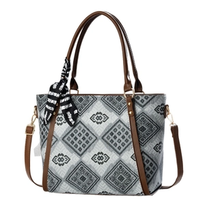 Fashionable grey geometric tote bag with brown leather handles and decorative silk scarf