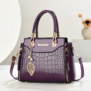 Deep purple faux leather crocodile pattern handbag with gold hardware and pearl leaf charm