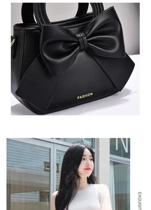 Close-up of black PU leather handbag with oversized bow detail and gold-tone logo