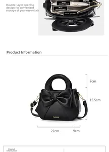 Detail view of black leather handbag featuring interior pockets and dimensions 22x9x15.5cm
