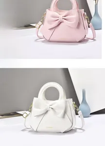 Detailed close-up of the elegant pink and white handbags with leather bow and FASHION logo