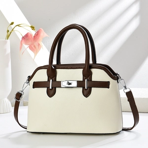 Minimalist shell-shaped crossbody bag in off-white leather with brown top handles