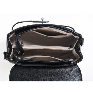 Detail view of the black lychee pattern leather bag interior with multiple compartments