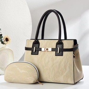 Beige pleated texture handbag set with brown handles and gold hardware on white background