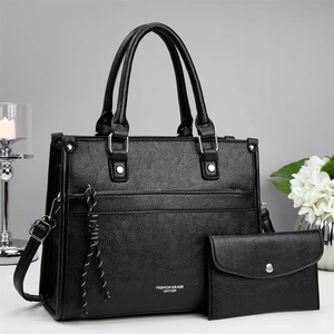 Fashionable black pebbled leather tote bag set with stylish woven lanyard detail