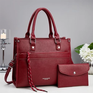 Red pebbled leather tote and wallet set with metal studs and tassel details