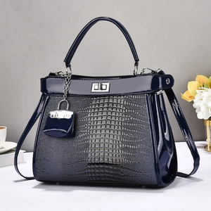 Navy blue crocodile pattern leather handbag with metallic hardware and top handle