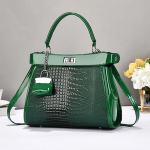 Dark green crocodile embossed handbag with silver clasp and matching mini pouch charm