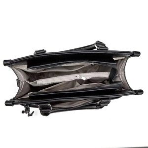 Interior view of black pebbled leather handbag showing multiple compartments and zipper pocket