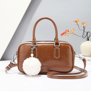 Retro Boston handbag in dark brown faux leather with plush ball charm and strap