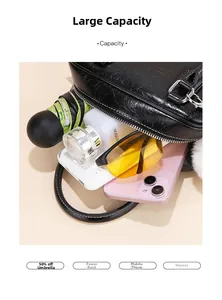 Flat lay showing large capacity of the black textured leather handbag with daily items